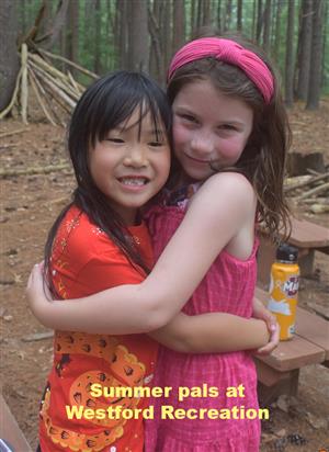 Two pals hugging at Westford Recreation summer program.